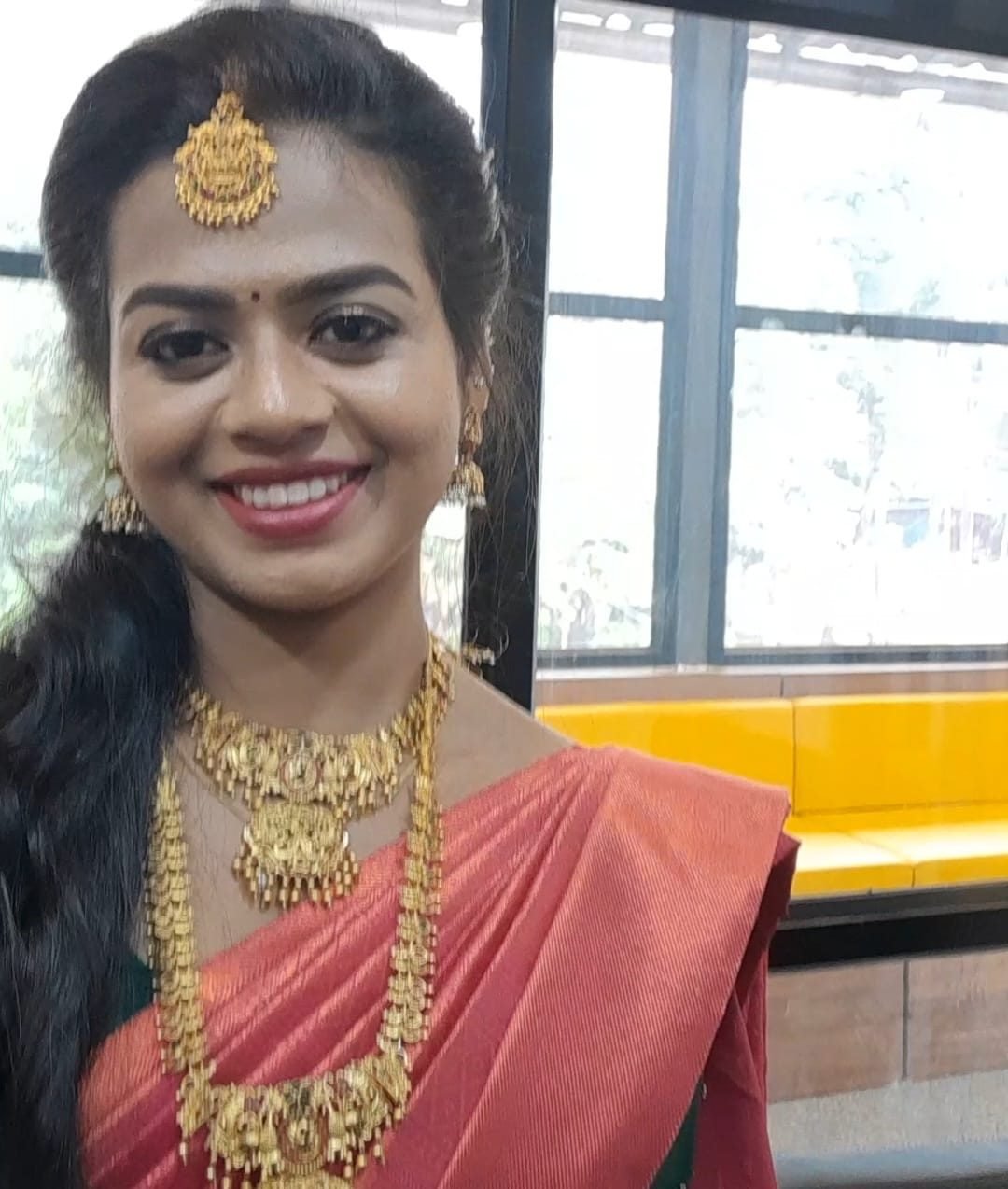 Bridal client smiling with gold jewellery set